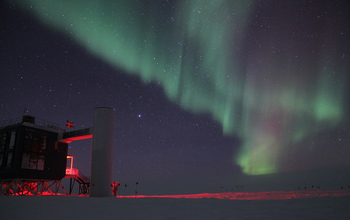 The aurora australis shines above NSF's IceCube Neutrino Observatory at NSF's Amundsen-Scott South Pole Station.